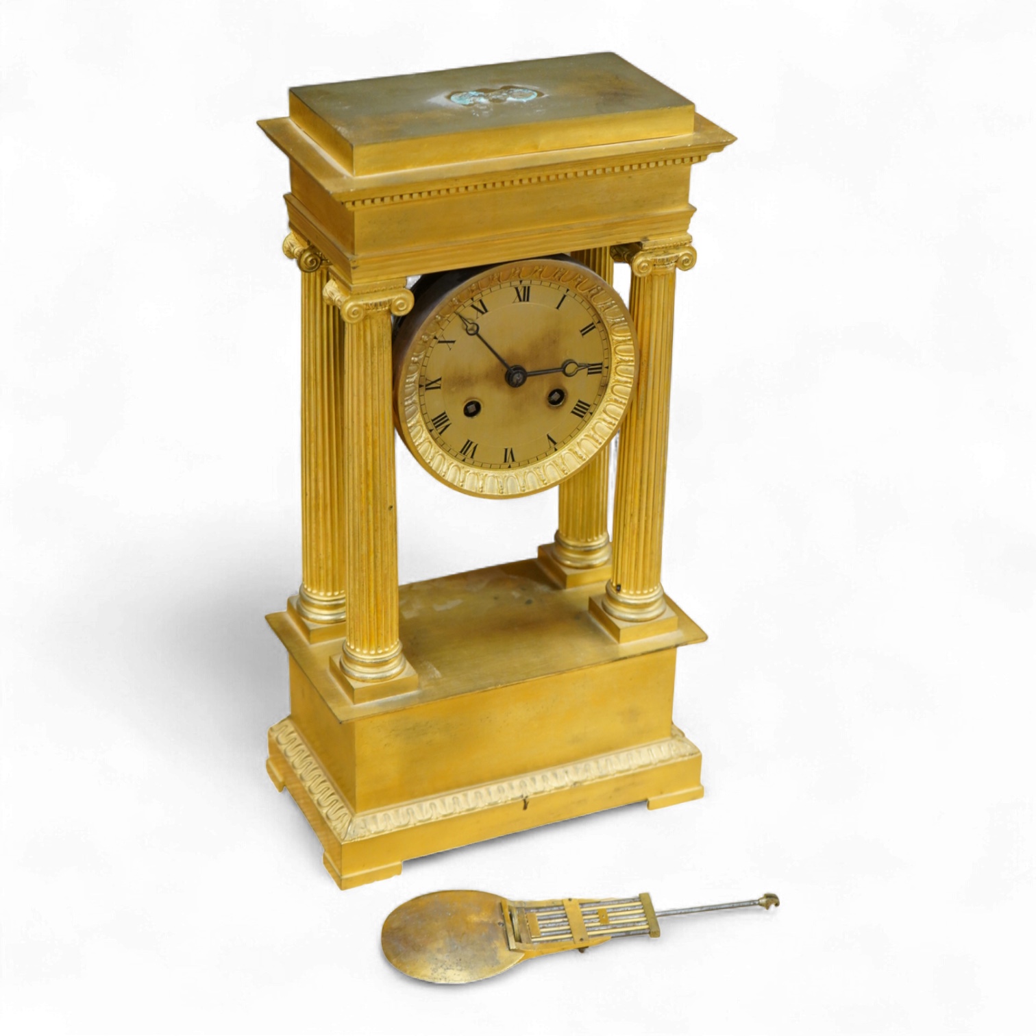 A 19th century French gilt brass eight day portico clock with pendulum, 38cm